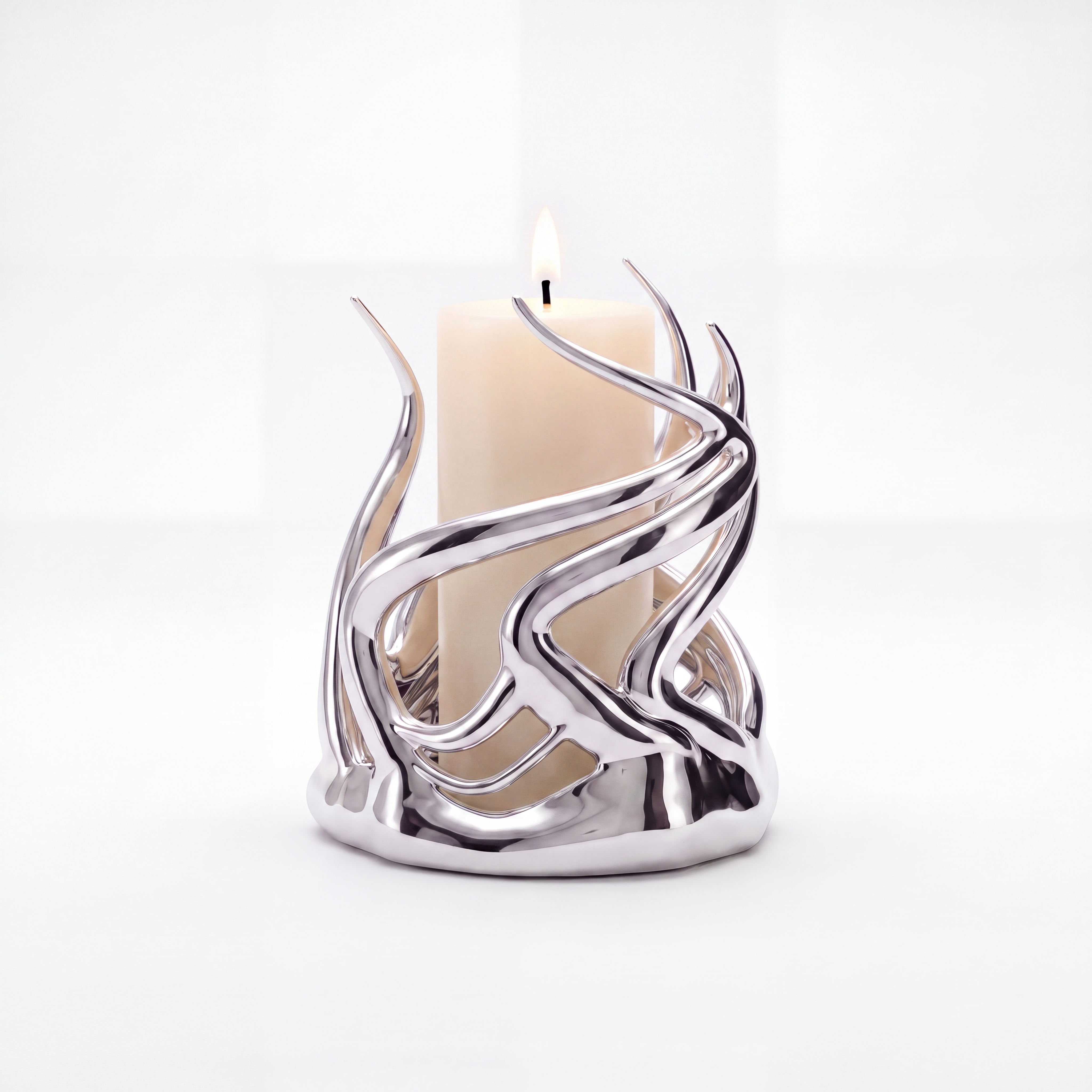 Sculptural silver candle holder with sharp flowing branches around a lit pillar candle